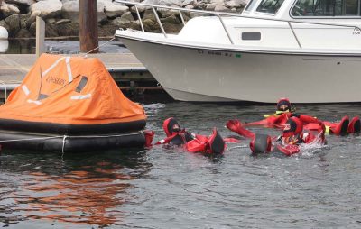 Trainees reach the life raft.