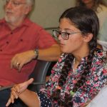 Emily Kollmer, a recent graduate of the marine vertebrate biology program at Stony Brook University, asks a question during the forum.