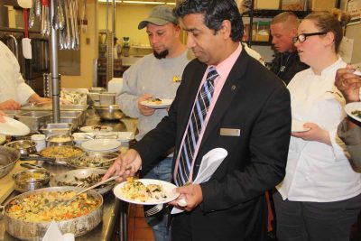 Jude Mascarenhas, director of operations at the Sheraton, tries some of the rice pilaf and other dishes with chefs who gathered in the hotel kitchen to learn about kelp from chef Jeff Trombetta.