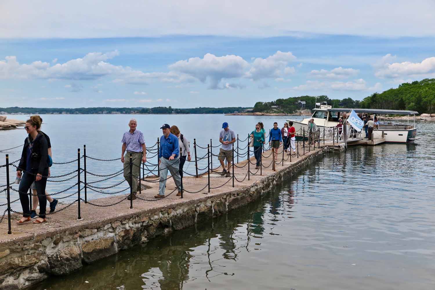 Passengers on the on-the-water workshop get off the Volsunga IV on the dock at Outer Island, part of the Stewart B. McKinney National Wildlife Refuge.