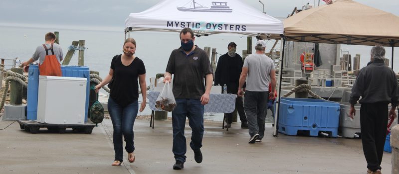 Noank.coop.direct.sales Customers leave with oysters and lobsters purchased on May 23 at the new direct sales market at the Noank Aquaculture Cooperative.