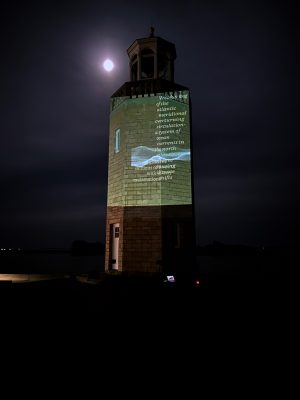 a "Reading the Wrack Lines"Image of a "Reading the Wrack Lines" digital video projection on the UConn Avery Point Lighthouse