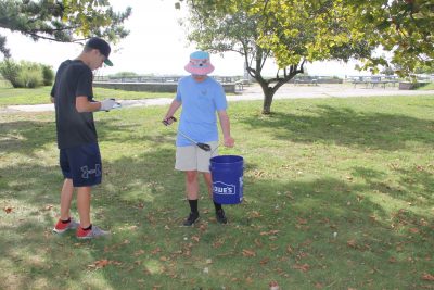 : Logan Stollenwerck, left, and Zacharie Aldrich, both volunteers at the Maritime Aquarium of Norwalk, were among the more than 25 volunteers who participated in the cleanup at Sherwood Island State Park in Westport to kick of the #DontTrashLISound - #DoOneThing campaign.
