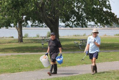 Marc Montillier, left, and Jean-Pierre Montillier of Westport, members of the Y’s Men, collected most of the trash they collected from the jetties.