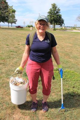 Nancy Balcom, associate director of Connecticut Sea Grant, filled several buckets with trash from the shoreline and lawns at Seaside Park.