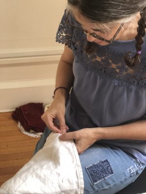 Marsha Borden works on one of her fiber art creations.