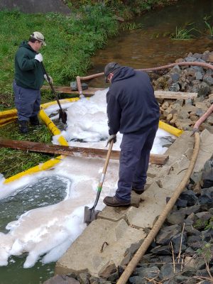 CT DEEP crews work to contain a spill of firefighting foam after it spilled into a tributary of the Farmington River in 2019.