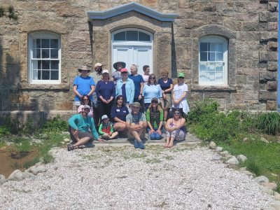 Participants in the May 2022 LIS Mentor Teacher Program gather in front of the lighthouse at Sheffield Island in Norwalk.